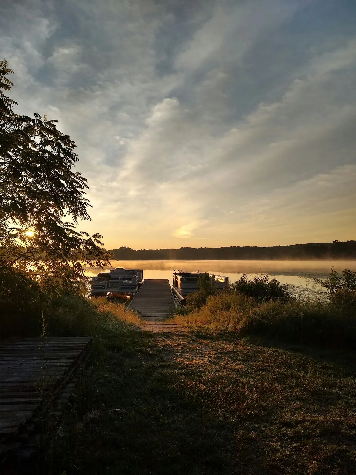 A wooden dock at sunrise on a Michigan lake